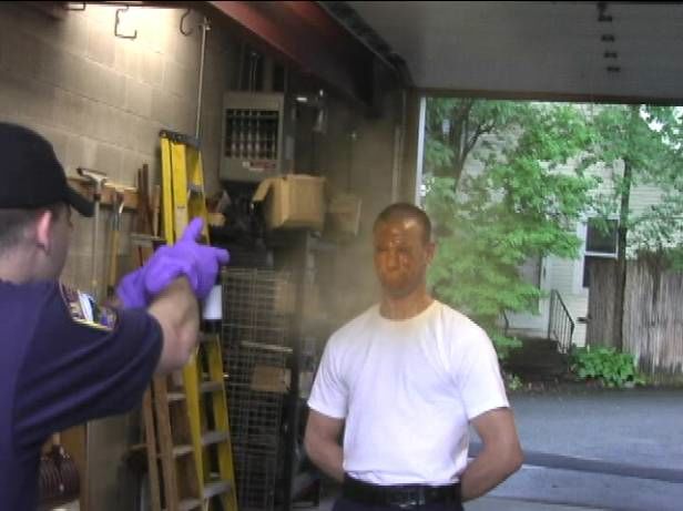  man being sprayed with hose